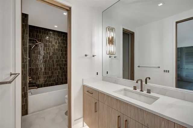 a bathroom with a double vanity sink a mirror and shower