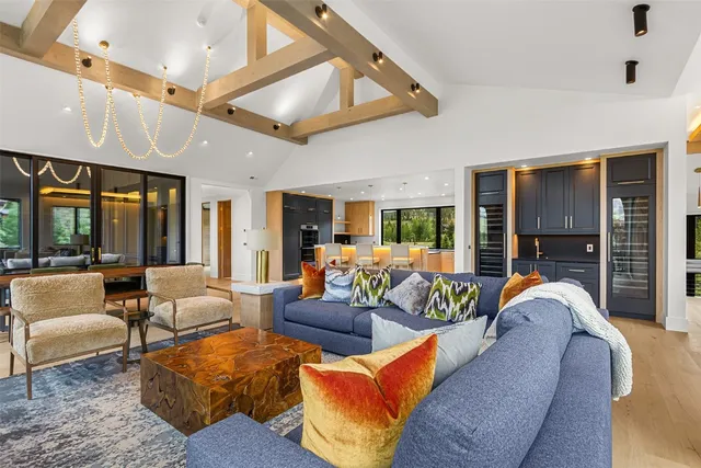 a living room with furniture fireplace and a large window