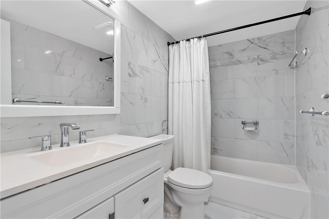 95 North Birch Road, Unit 405 Fort Lauderdale, FL 33304 - Photo 14 of 34 a bathroom with a sink a toilet and a bathtub