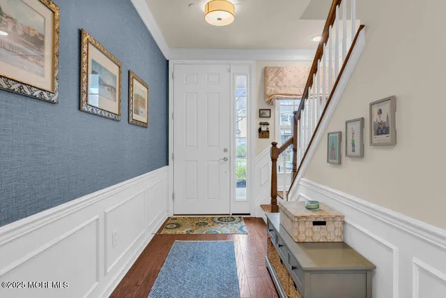 a living room with furniture flat screen tv and wooden floor