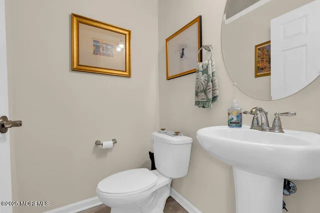 a living room with furniture kitchen view and a chandelier