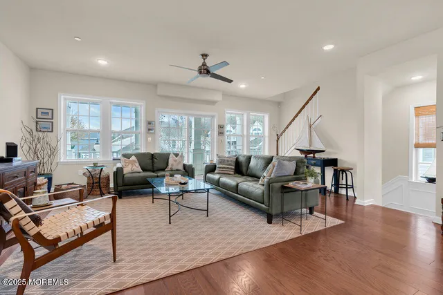 a view of a dining room with furniture a rug and wooden floor