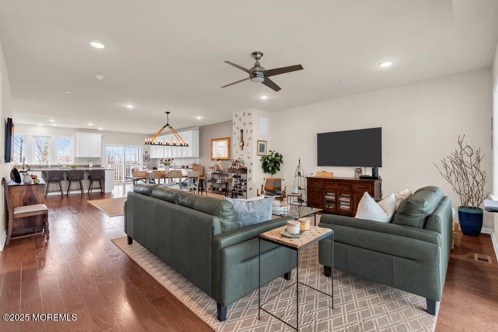 24 Lighthouse Point Road Highlands, NJ 07732 - Photo 19 of 63 a living room with furniture a flat screen tv and kitchen view