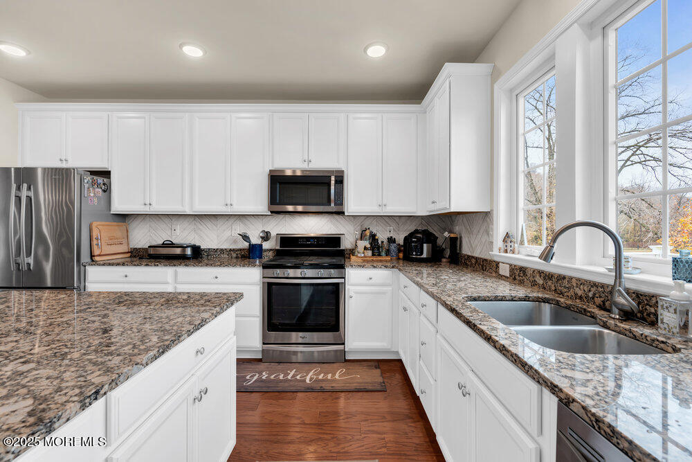 24 Lighthouse Point Road Highlands, NJ 07732 - Photo 27 of 63 a kitchen with stainless steel appliances granite countertop a sink dishwasher a stove top oven a refrigerator with granite countertops and cabinets