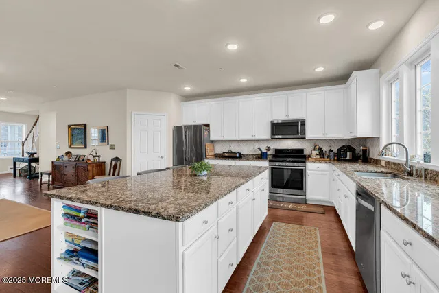 a kitchen with sink stove and cabinets