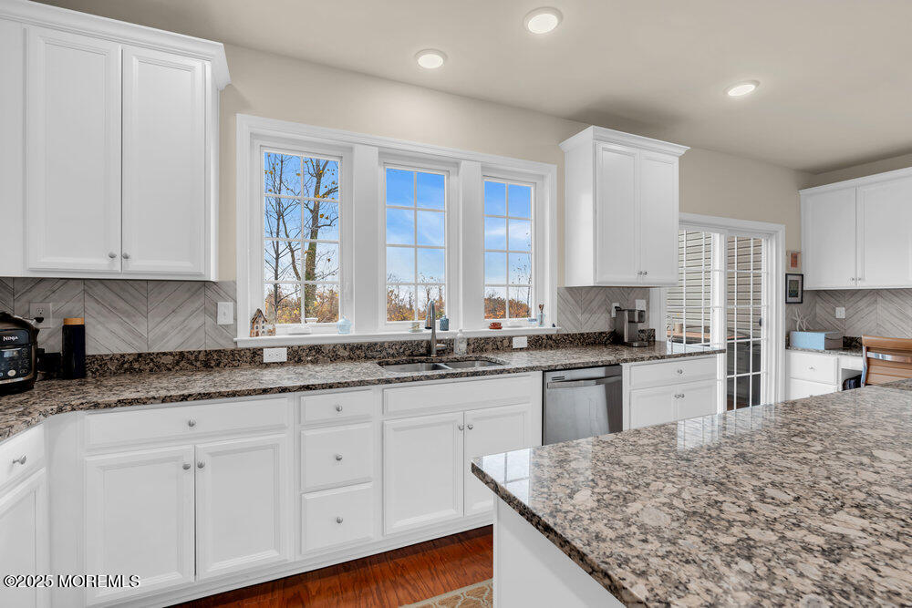 24 Lighthouse Point Road Highlands, NJ 07732 - Photo 28 of 63 a kitchen with granite countertop white cabinets white appliances and a sink