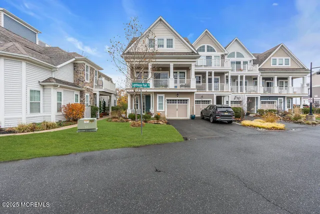 a car parked in front of a house next to a yard