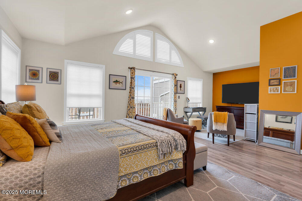 24 Lighthouse Point Road Highlands, NJ 07732 - Photo 35 of 63 a bedroom with a bed and wooden floor