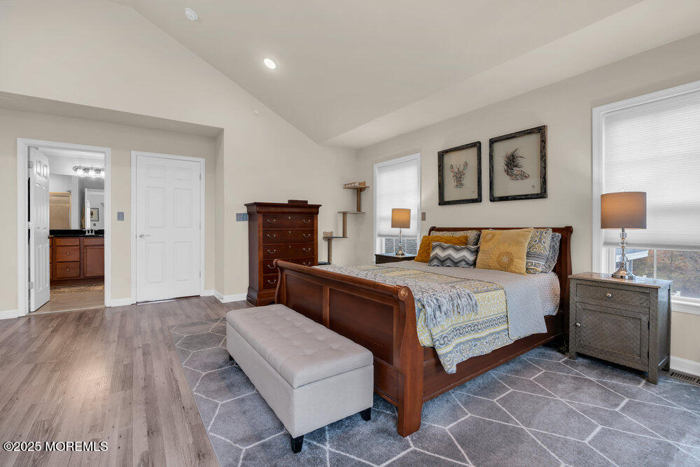 24 Lighthouse Point Road Highlands, NJ 07732 - Photo 37 of 63 a bedroom with a bed and lamp