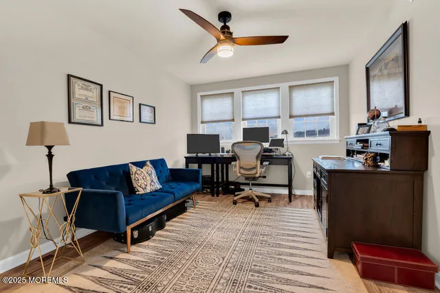a view of a balcony with floor to ceiling window and wooden fence