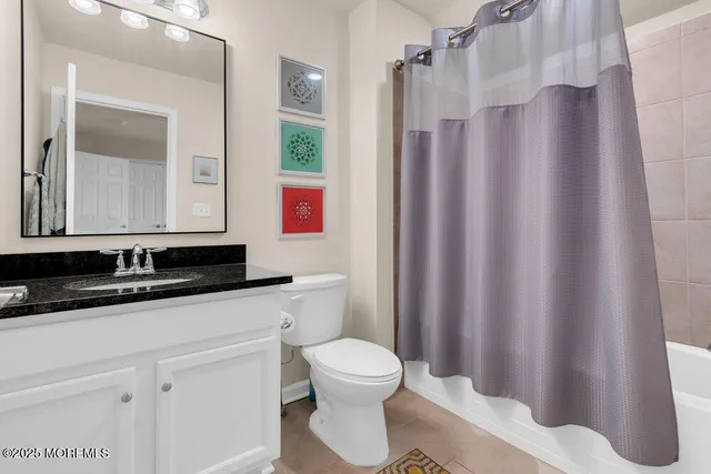 a view of a big house with a yard and large trees