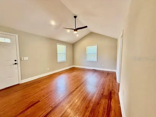 wooden floor in an empty room with a window