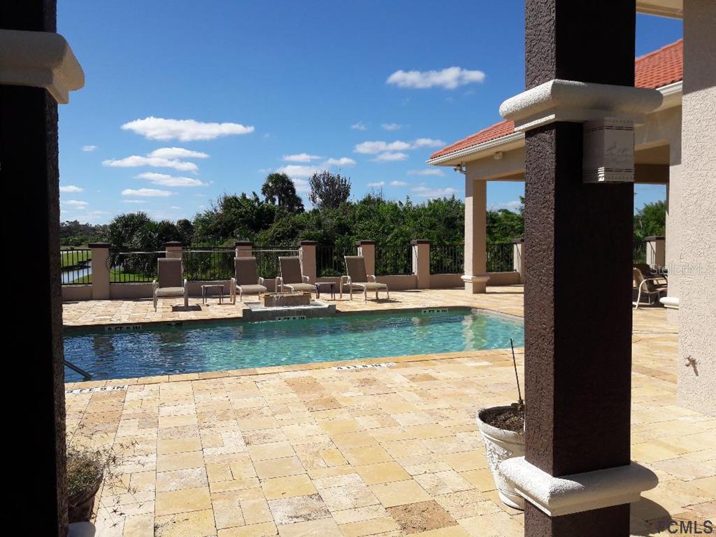62 Malibu Cove Beverly Beach, FL 32136 - Photo 9 of 14 a view of a swimming pool with a patio
