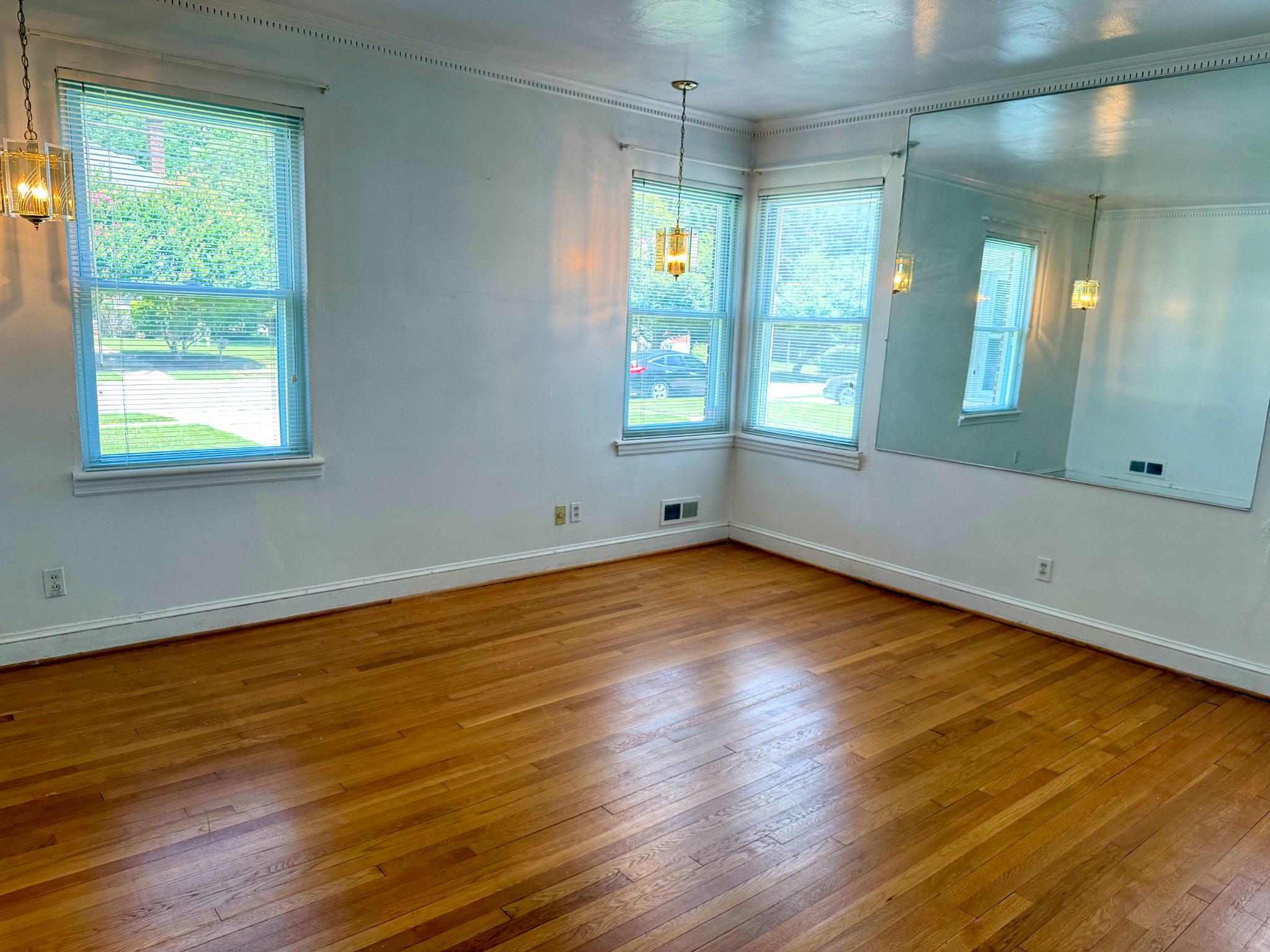 6318 Winner Avenue Baltimore, MD 21215 - Photo 37 of 75 an empty room with wooden floor and windows
