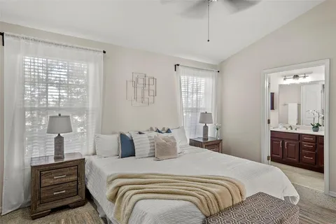 a bedroom with a balcony a bed and a dresser