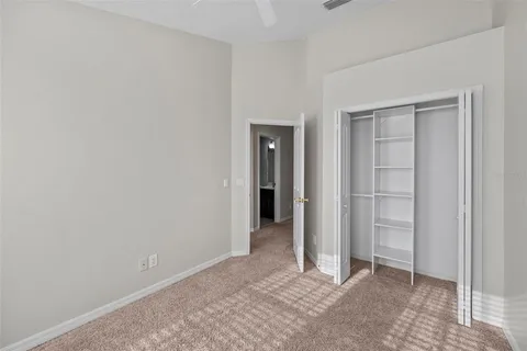 a view of an empty room with closet