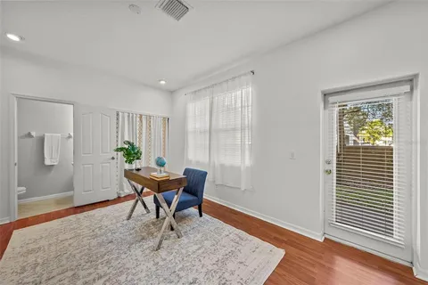 a workspace room with furniture and wooden floor