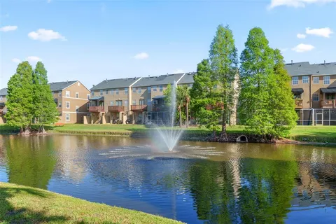 a view of building with river in front of it