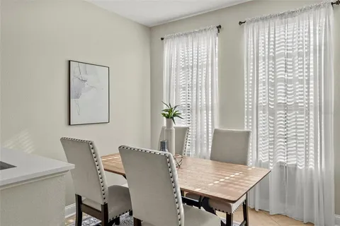 a view of a dining room with furniture and window