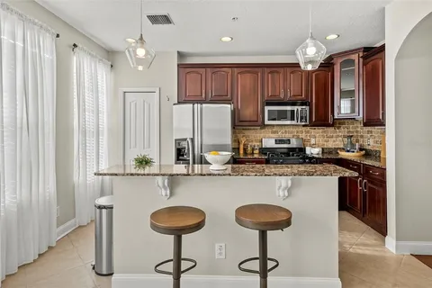 a kitchen with stainless steel appliances granite countertop a stove and a refrigerator