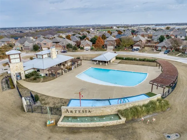 an aerial view of a house with a yard