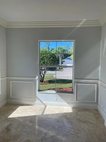 front view of a brick house with a yard