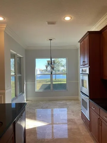 a kitchen with stainless steel appliances a stove a sink and a microwave