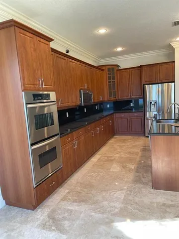 a kitchen with a sink and a refrigerator