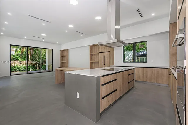 a large white kitchen with a large window