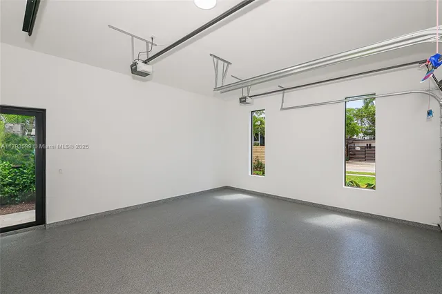 a living room with furniture a table and kitchen view