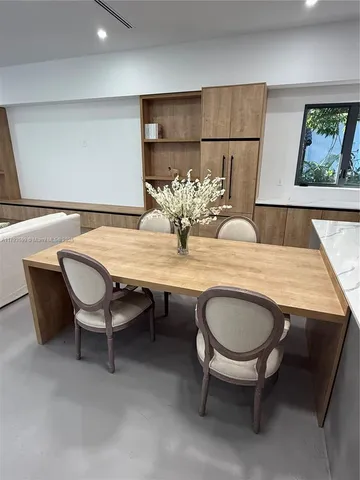 a spacious bedroom with a bed and large window