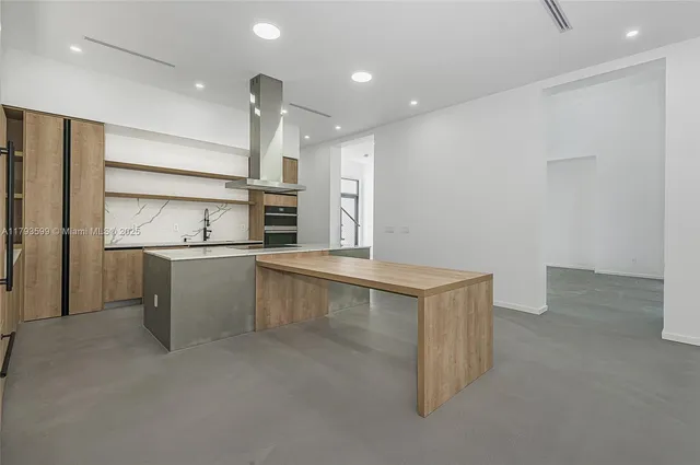 a kitchen with stainless steel appliances a sink and a refrigerator