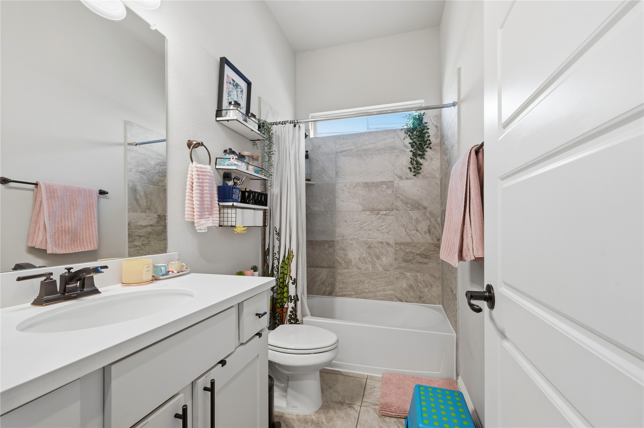 138 Rpd Spgs Cove Georgetown, TX 78628 - Photo 15 of 37 a bathroom with a bathtub shower sink vanity mirror and toilet