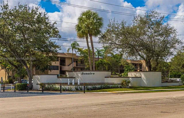 a front view of a house with a garden and plants
