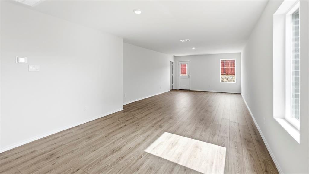 3519 Spring Time Street Forney, TX 75126 - Photo 28 of 37 Spacious room featuring wood-finish flooring, recessed lighting, and multiple windows