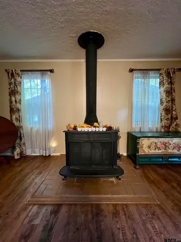 a living room with a mirror and furniture