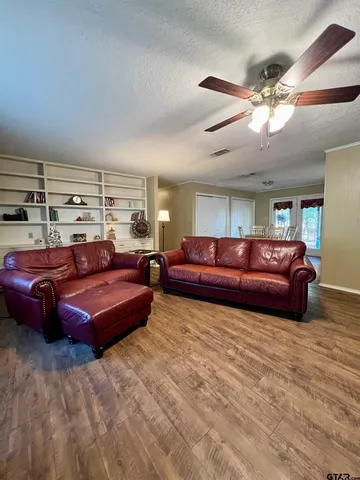 a room with furniture and book shelf