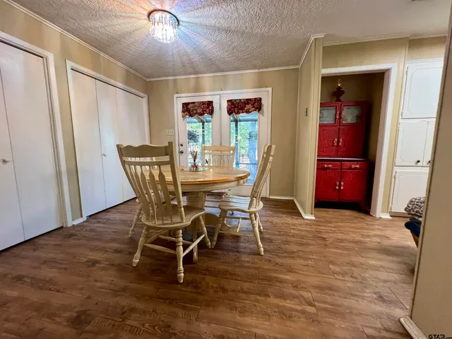 a dining room with furniture and wooden floor