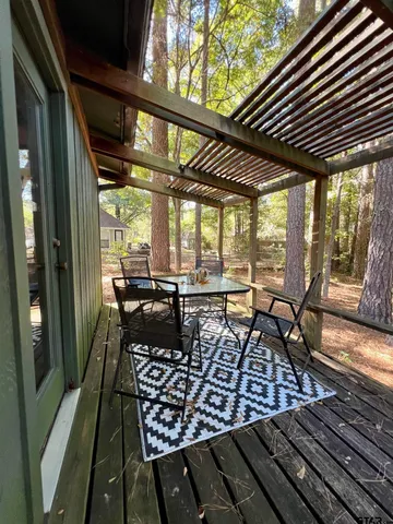 a living room with a floor to ceiling window and wooden floor