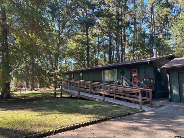 a view of a house with swimming pool and sitting area