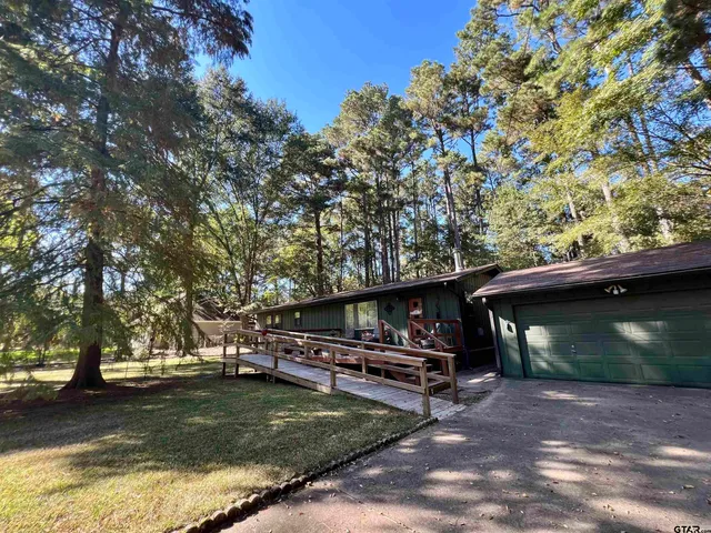 a view of outdoor space with swimming pool and trees