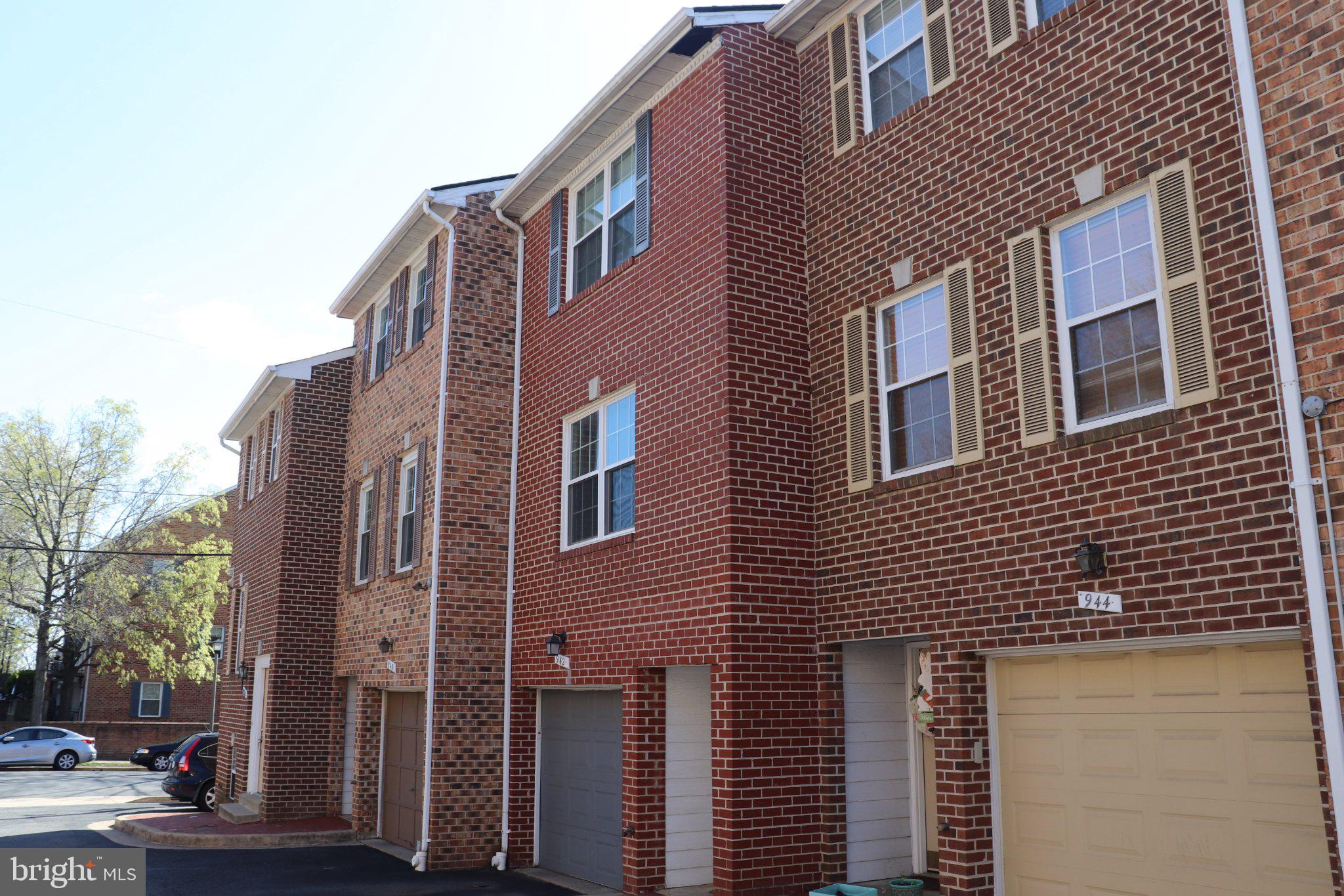 Charming brick townhomes in sunlight.