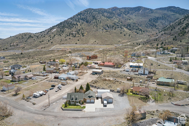 151 South Haulage Road Eureka, UT 84628 - Photo 31 of 36 Aerial view of property and surrounding area with a mountain backdrop and nearby suburban area