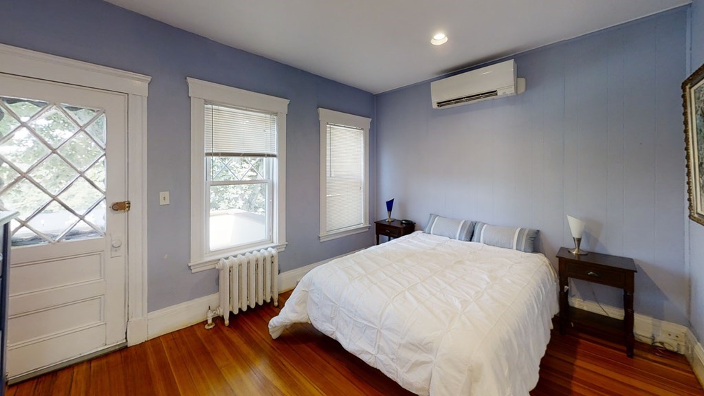 307 Tappan Street, Unit 3 Brookline, MA 02445 - Photo 11 of 13 a bedroom with a bed and wooden floor
