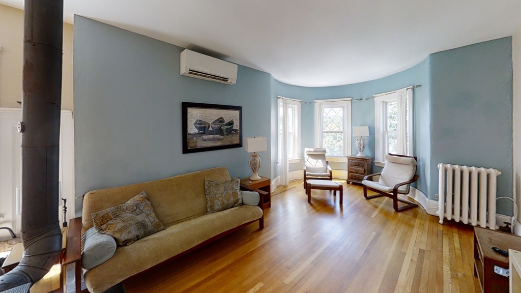 307 Tappan Street, Unit 3 Brookline, MA 02445 - Photo 2 of 13 a living room with furniture and wooden floor