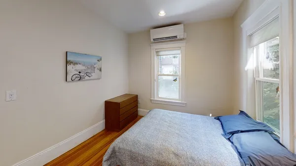 a bedroom with a bed and a dresser