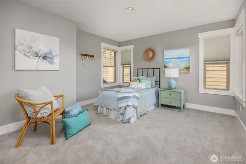 a bed room with a bed and a chair