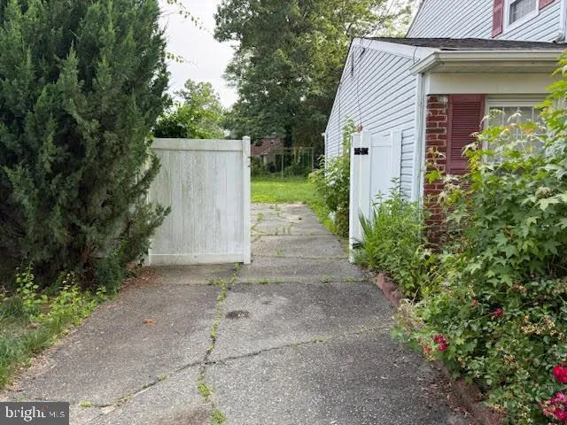 a backyard of a house with plants and trees