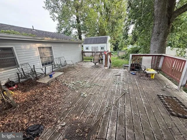 a view of backyard with a deck and wooden floor
