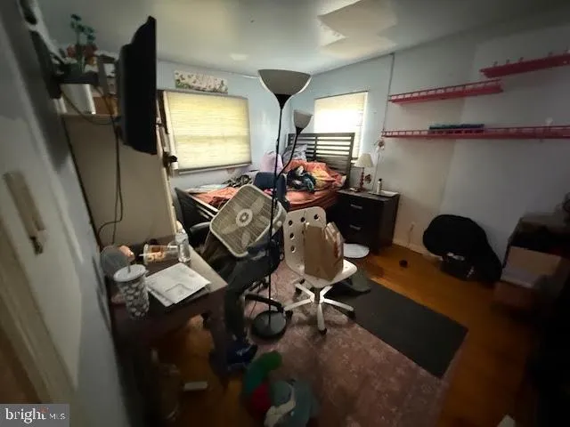 a view of a workspace with furniture and a window